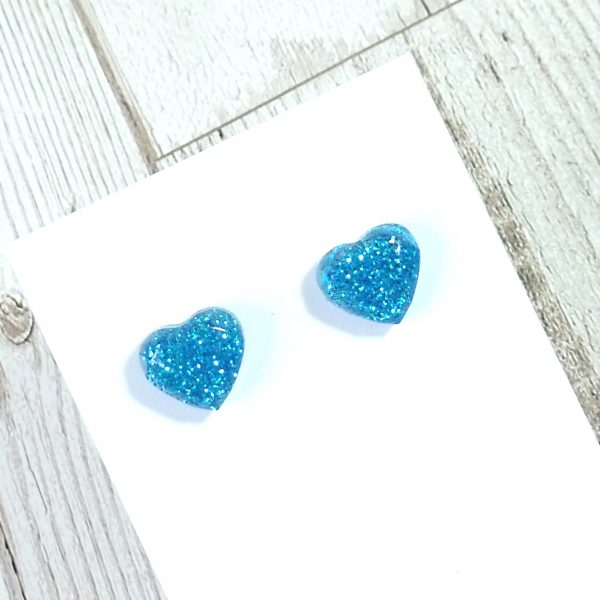 Turquoise glitter heart studs on card