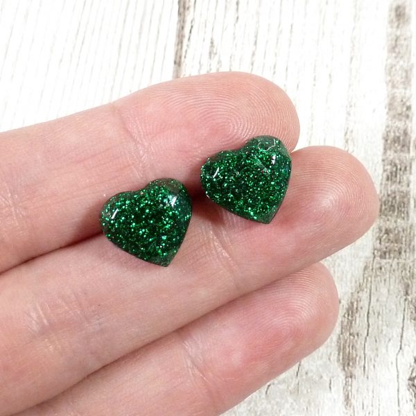 Green Glitter heart studs on hand