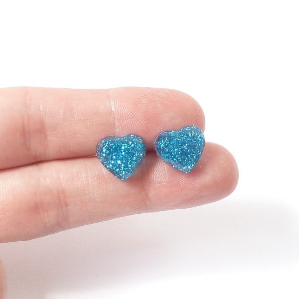 Turquoise glitter heart studs on hand