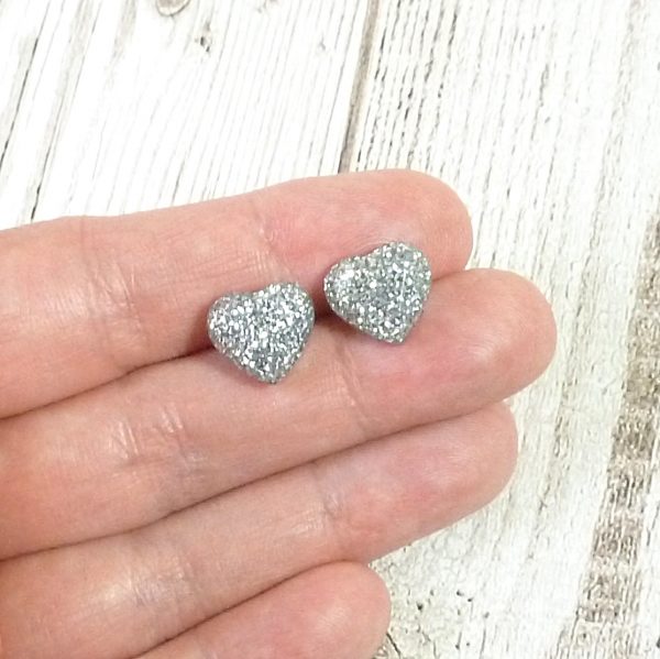 Silver Glitter heart studs on hand