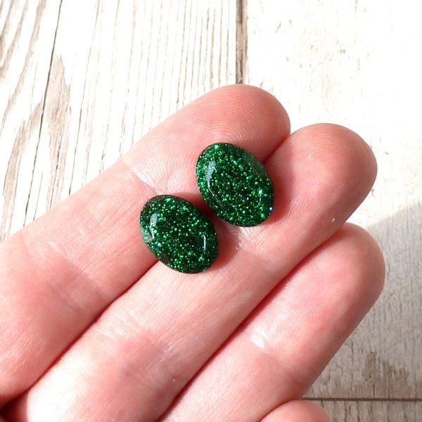 Green oval glitter studs on hand