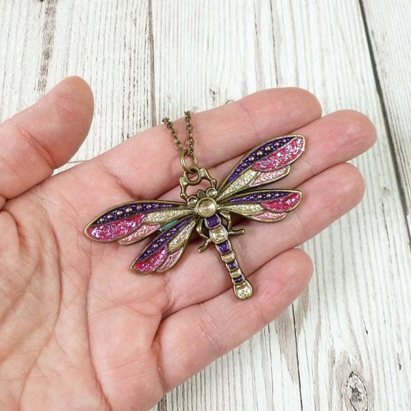 Rose Gold Pink and Purple Dragonfly pendant on hand