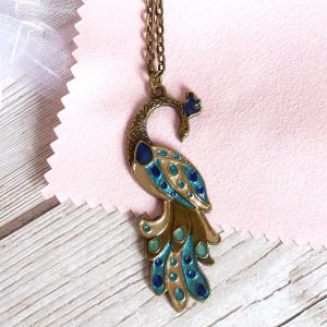 blue gold turquoise peacock on bronze on pink