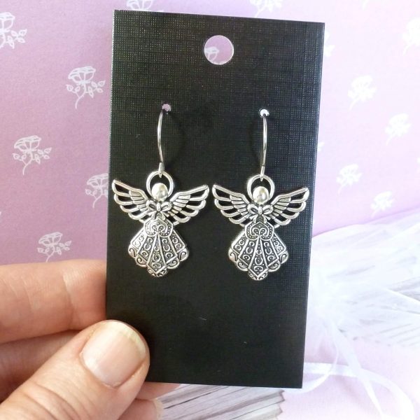 Silver angel earrings on card