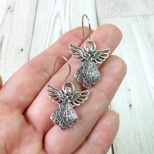 silver angel earrings on hand