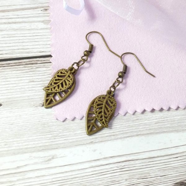 2 bronze leaves charm dangle on pink background