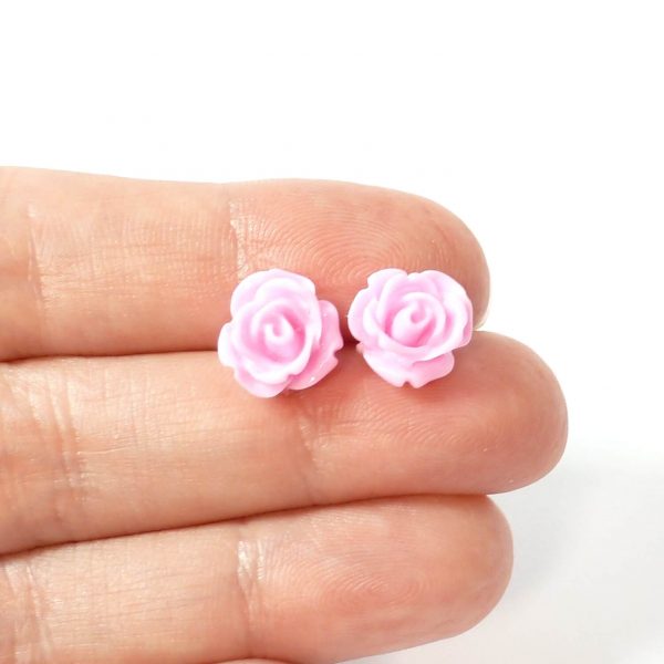 Pink rose studs on hand