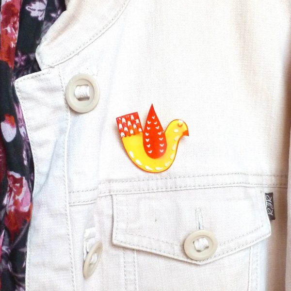 Yellow and red love bird brooch on jacket