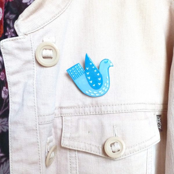 Blue love bird brooch on jacket