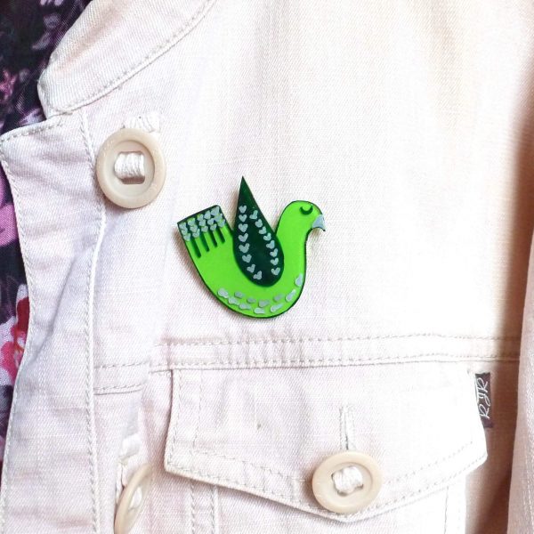 Green love bird brooch on jacket