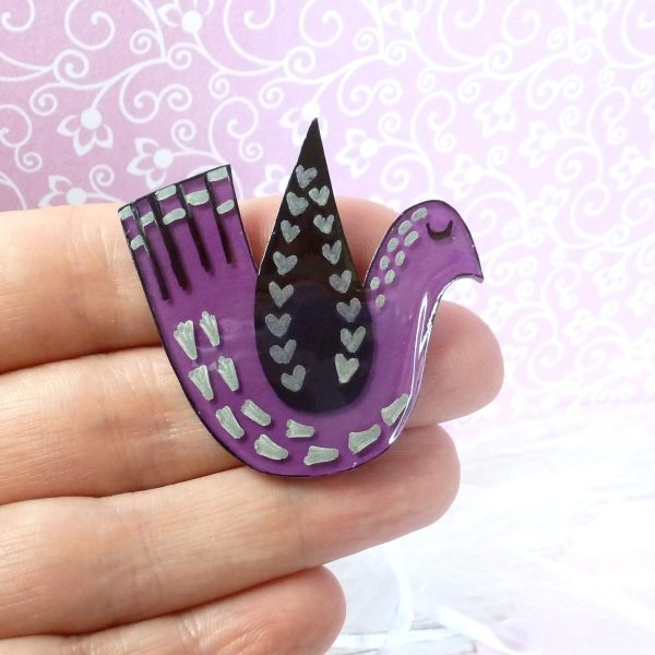 Purple love bird brooch on hand