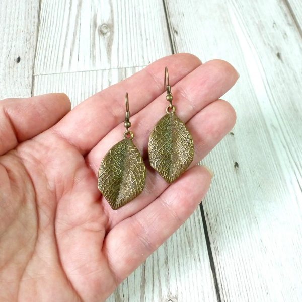 single leaf dangle earrings on hand