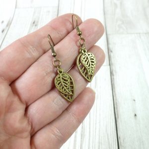 Double leaf charm dangle earrings on hand