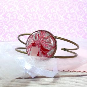 pink and silver swirls wire bracelet on pink view 1