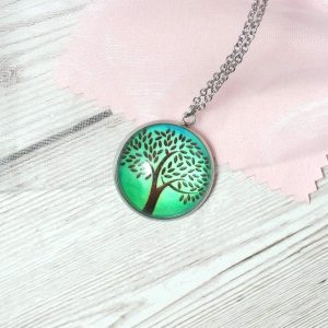 green tree cabochon pendant on pink background