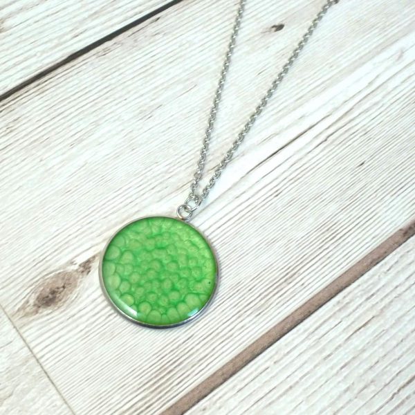 Emerald Green 25mm pendant on wooden background