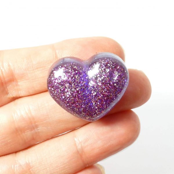 purple glitter heart pin on hand