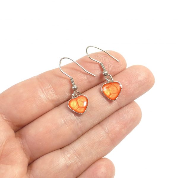 Orange Steel Heart Dangle Earrings on hand