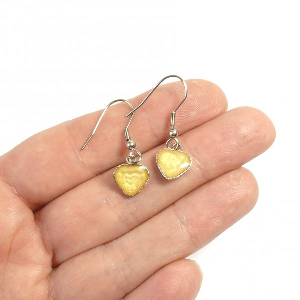 Yellow Steel Heart Dangle Earrings on hand