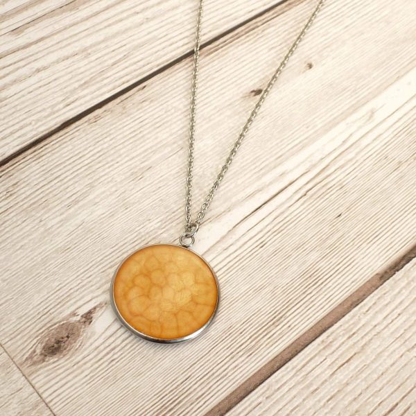Yellow 25mm pendant on wooden background