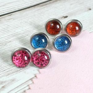 10mm blue pink red studs on wooden background