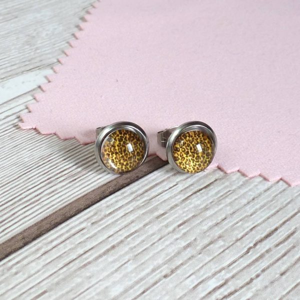 10mm gold studs on wooden background