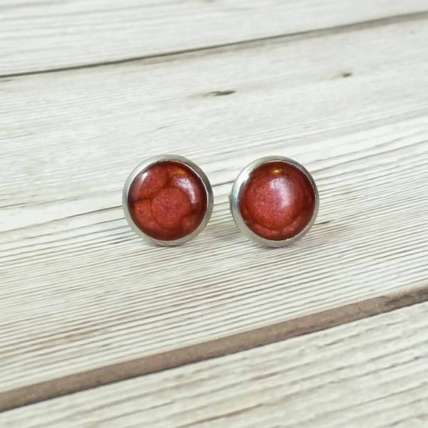 10mm red steel studs on wooden background
