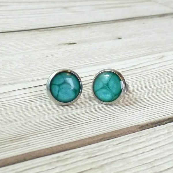 10mm turquoise steel studs on wooden background