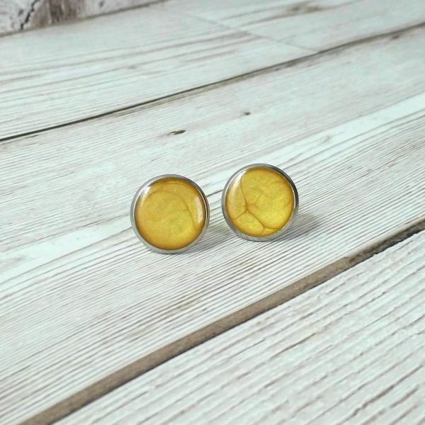 14mm yellow steel studs on wooden background