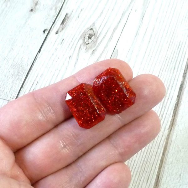 red glitter large octagon studs on hand