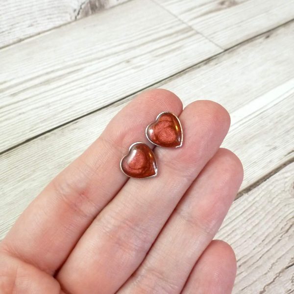 red heart studs on hand