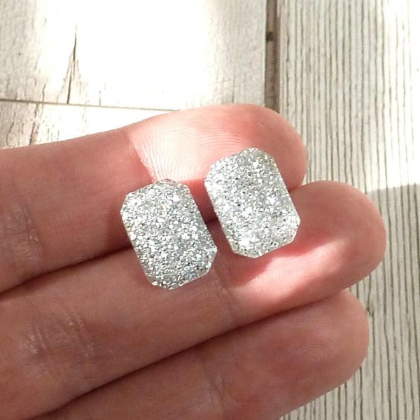 silver small octagon studs on hand