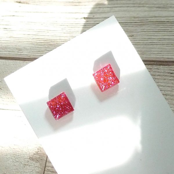 tiny hot pink square studs on card