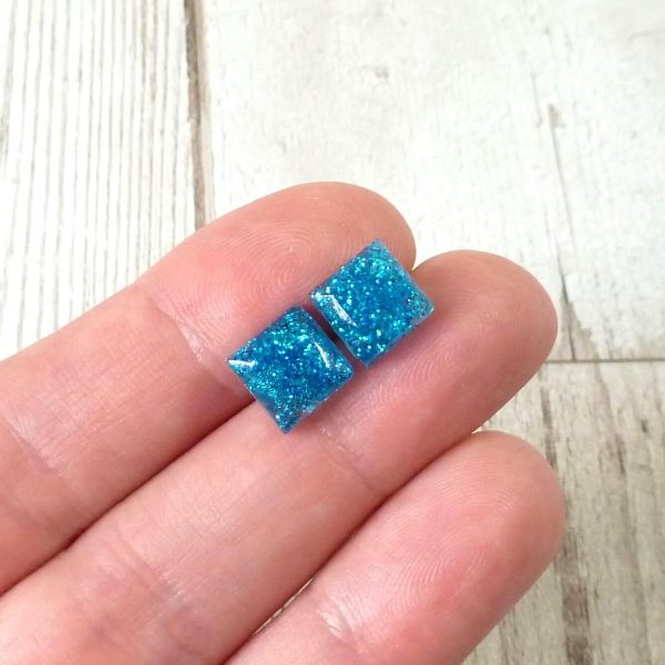 tiny turquoise square studs on hand