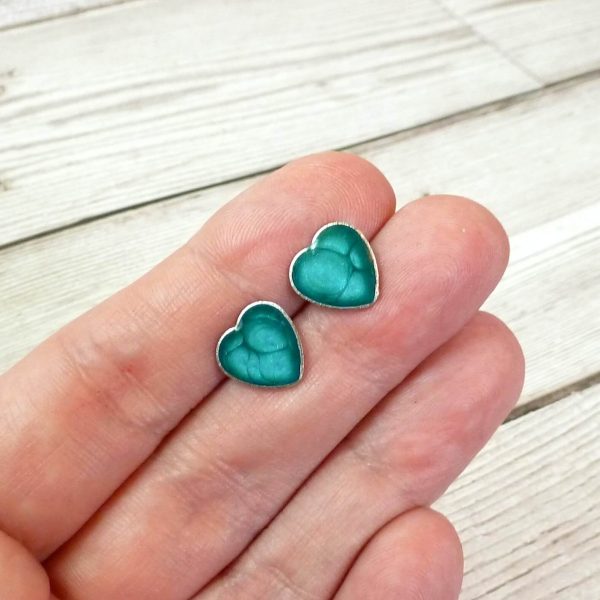 turquoise heart studs on hand