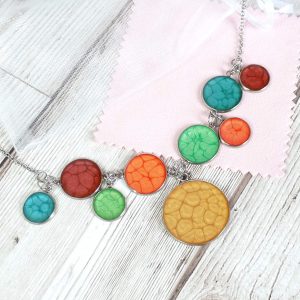 9 bezel rainbow necklace on wooden background