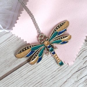 blue teal and gold dragonfly on pink view 1