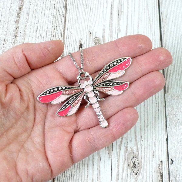 pink pink rose dragonfly on hand